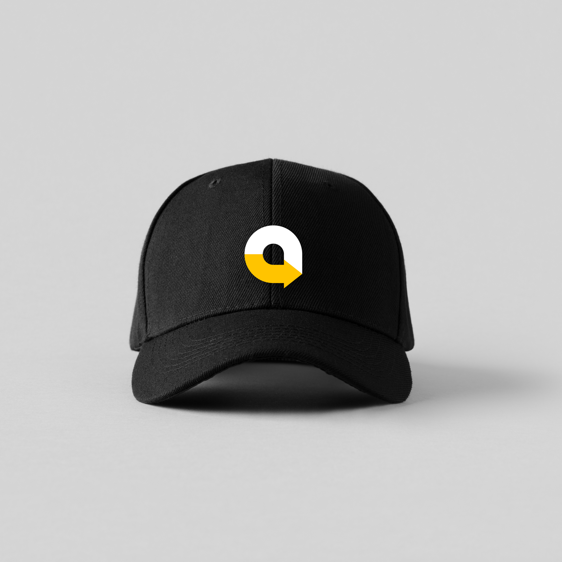 Black cap with a white and yellow logo on a gray background